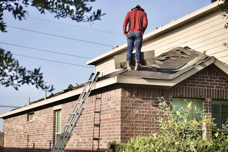 Professional roofer working on a residential roof in Firetown